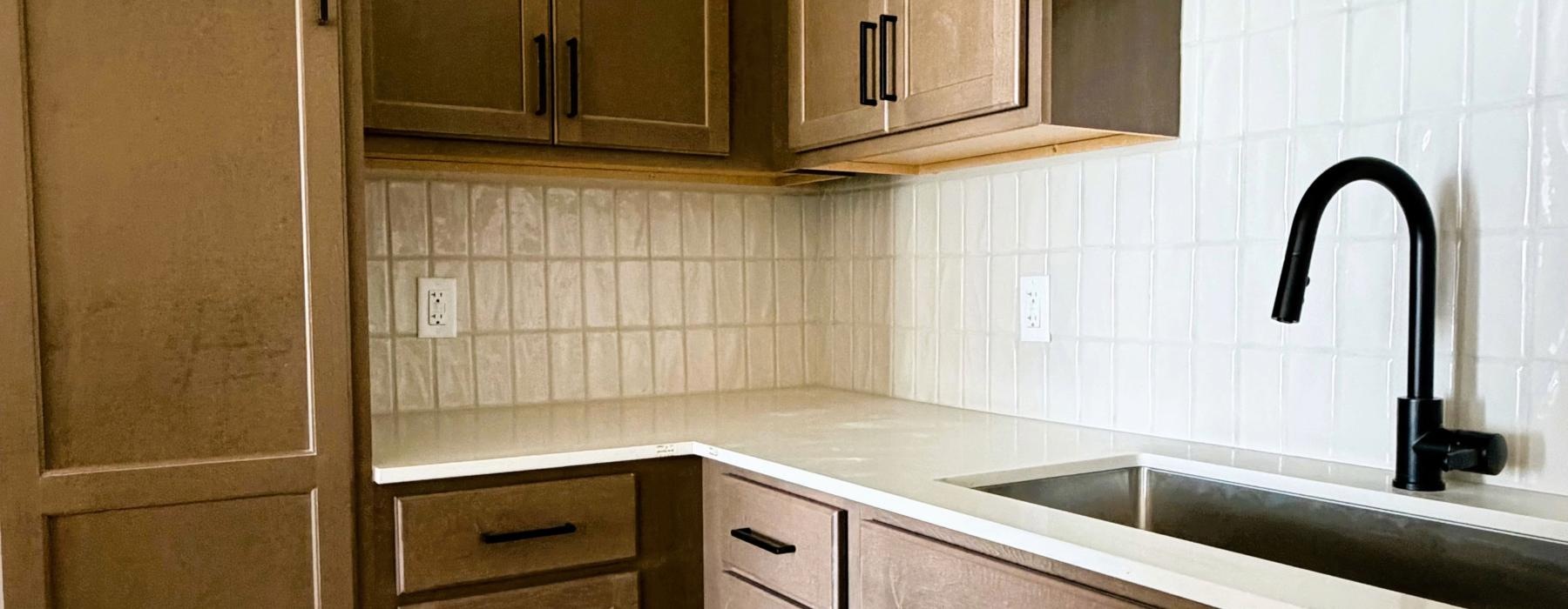 a kitchen with wooden cabinets